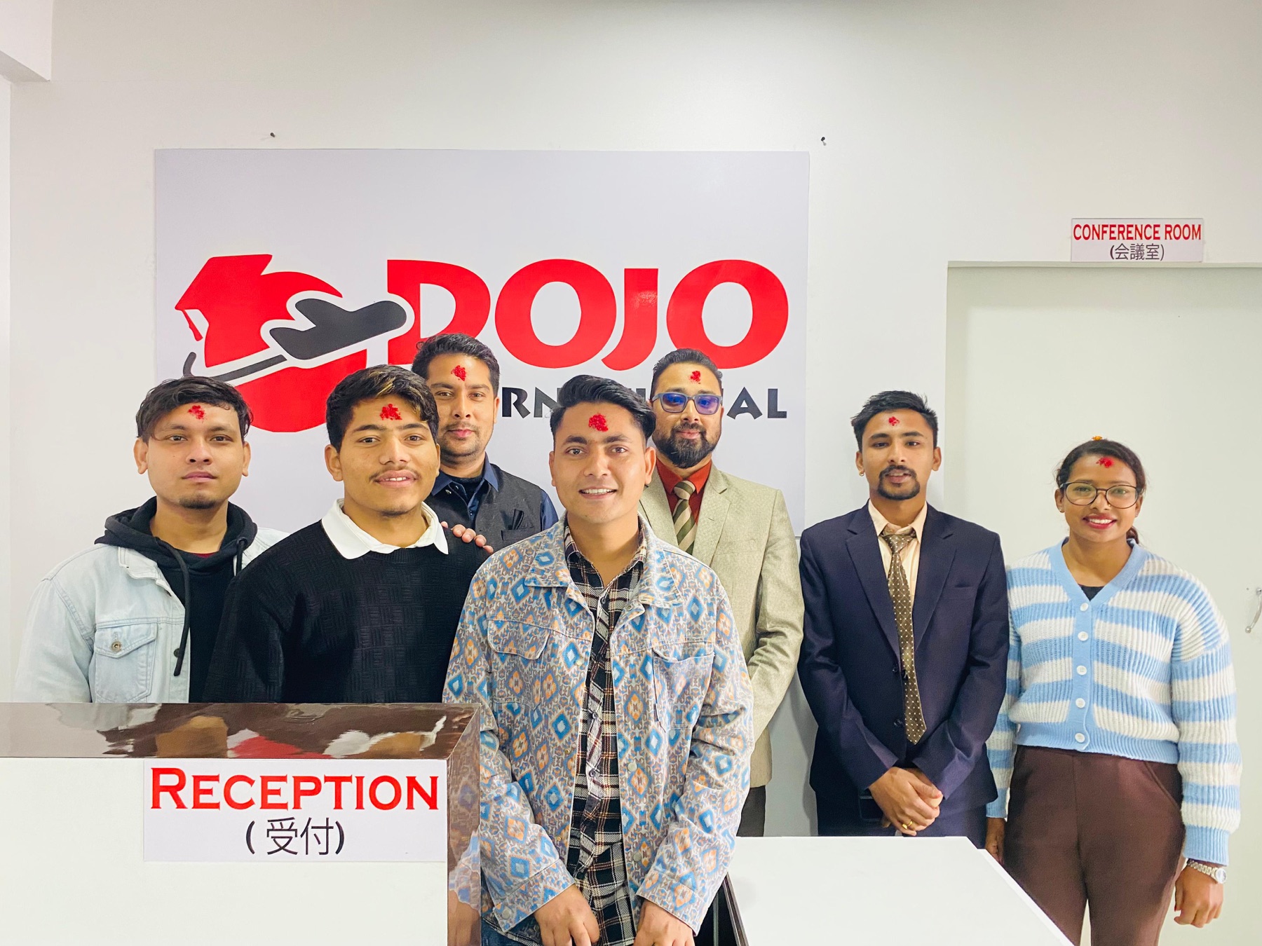 Dojo International team at the school's reception entrance in Kathmandu